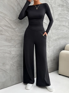 Close-up detail of soft black fabric on Y2K long sleeve slim top and wide leg pants set