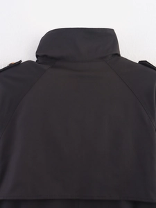 Detail view of black windbreaker featuring a high collar and reinforced stitching