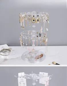 Close-up of a 2-tier rotating acrylic jewelry stand with earrings and tray base
