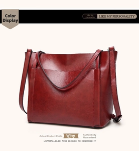 Detail view of burgundy oil wax leather tote bag with dual handles and soft texture