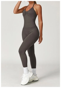 Detail of high-waist seamless compression yoga leggings and ruched sports bra in dark grey
