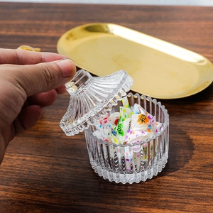 European crystal glass candy jar with vertical ribbed pattern and elegant lid handle