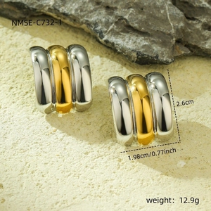 Macro detail of bicolor C-shape titanium steel earrings with 18k gold plating and size data