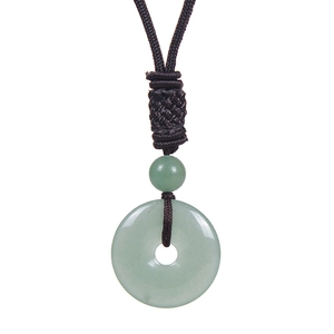 Macro shot of green jade safety buckle pendant with brown woven cord on white background