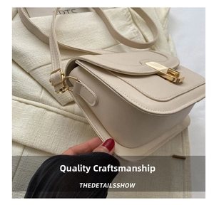Close-up of cream crossbody bag featuring a golden rectangular turn-lock and fine PU leather