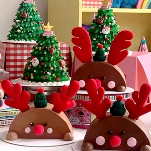 Detailed close-up of reindeer chocolate cake and Christmas tree buttercream cupcake