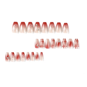 Red gradient press-on nails with heart rhinestones and lattice patterns in coffin shape