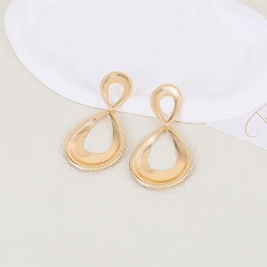 Vintage hollow double ring gold drop earrings with intricate textured radial stripes