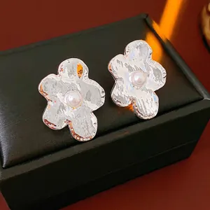 Irregular textured silver flower earrings with white pearls on black leather box