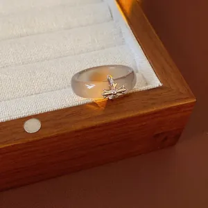 Vintage chalcedony resin ring with gothic cross pendant on white jewelry display