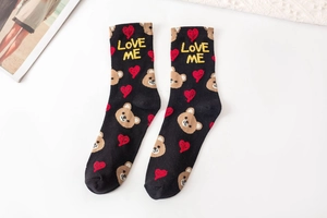 Detail of black cotton mid-tube socks featuring cute bear and Love Me lettering embroidery