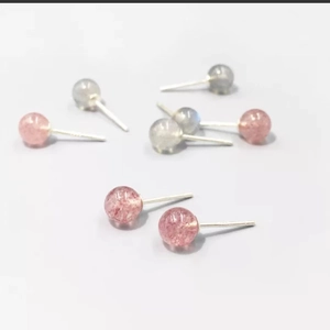 Close-up of S925 sterling silver studs featuring natural pink quartz and moonstone beads