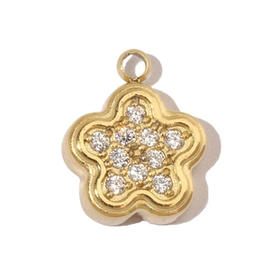 Macro detail of a gold flower pendant with hand-set cubic zirconia and five petals