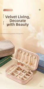 Pink velvet jewelry box organizer featuring earring hooks and ring slots in detail