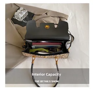 Internal view of large leopard print handbag showing spacious storage and golden hardware