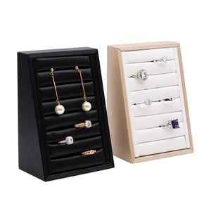 Black and beige jewelry display stands with multi-slot slots for rings and earrings