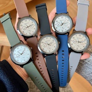 Detail of multi-color silicone strap quartz watches with large round dials in hand