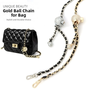 Close-up of adjustable metal chain straps with rhinestone gold balls and lobster clasps