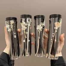 Detailed view of four Chinese style hairpins with floral patterns in transparent tubes