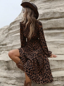 Detail of bohemian leopard print maxi dress with long sleeves and western style boots