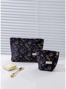 Two-piece navy blue floral embroidered canvas makeup bag set with gold daisy zippers