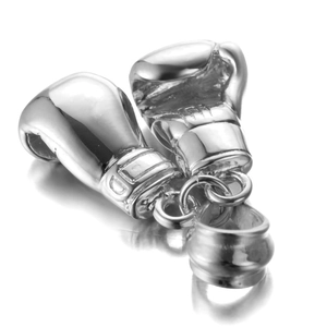 Macro shot of polished boxing glove pendants with glossy metallic finish and reflection