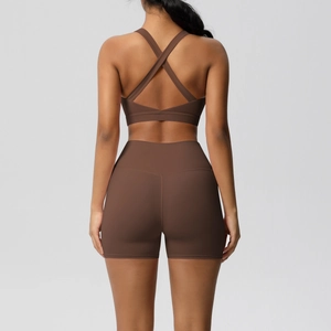 Detail of cross-back sports bra and high-waisted shorts in dark brown yoga set