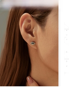 Close-up of S925 sterling silver evil eye stud earring with blue stone and pavé diamonds