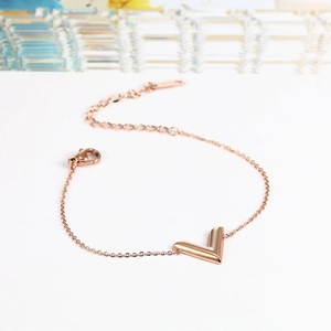 Macro shot of 18k rose gold plated V letter charm bracelet with lobster clasp and S925 stamp