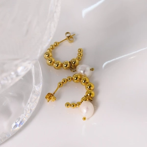 Golden titanium steel C-shaped earrings featuring metallic beads and white pearls