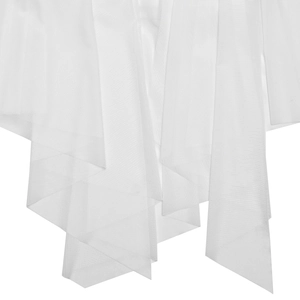 Close-up of white layered tulle fabric detail with asymmetric pointed hem and soft texture