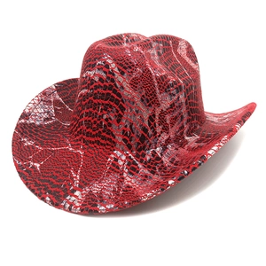 Detailed close-up of vibrant red snakeskin pattern on a wide-brim western cowboy hat
