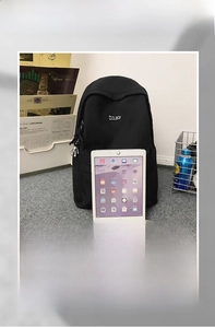 Detail view of large capacity black backpack showing interior storage for tablets and A4 files