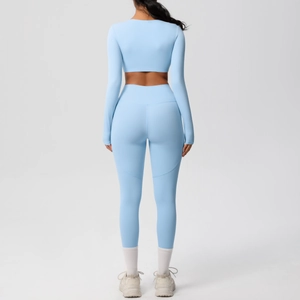 Rear view of a light blue long-sleeve crop top and high-waisted yoga pants set