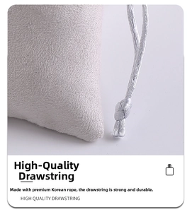 Macro detail of soft grey microfiber jewelry pouch showing durable drawstring cord texture