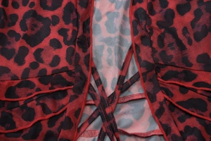 Detail of red leopard print mesh shirt with ruffles and criss-cross tie-up closure