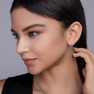 Elegant S925 sterling silver moissanite stud earrings on a model with a clean side profile