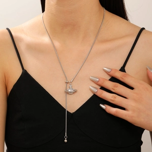 Detail of silver Saturn pendant necklace with shimmering rhinestones on a model