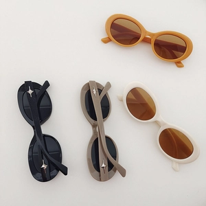Set of four retro oval kids' sunglasses with star-shaped accents and UV protection