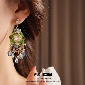 Bohemian rhombus drop earrings with colorful crystals and tassels on female model