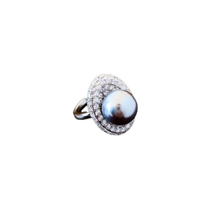 Elegant silver ring with gray pearl and double halo of white zircons on white background