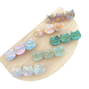 Cute acetate cat hair clips in sparkling gradient colors on a wooden display stand