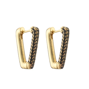 Macro detail of geometric V-shaped gold earrings with paved black zircon stones