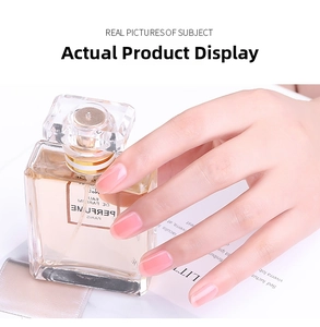 Detail showing translucent pink nail extension gel finish on hand with elegant props