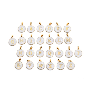 Macro view of 26-piece gold stainless steel initial charms with white shell inlay set