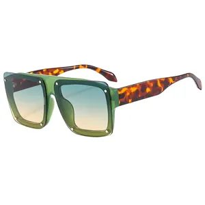 Square oversized sunglasses with green transparent frames and gradient colorful lenses