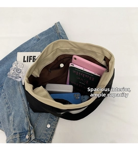 Top view of spacious interior of canvas tote bag with zipper pocket and accessories
