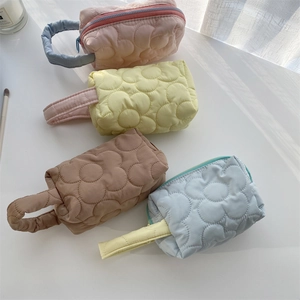 Cute quilted floral cosmetic bags in four vibrant colors with handles and zip closure