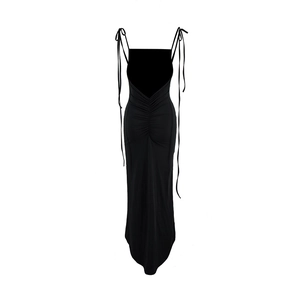 Detail view of backless black dress featuring ruching and drawstring tie design