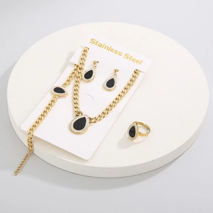 Detail view of a 4-piece gold stainless steel set with black teardrop shell pendants